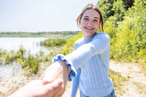 stock image The abstract image of the young attractive woman taking her lover hand in hand leading to the lakeside during sunset by pov camera angle . High quality photo