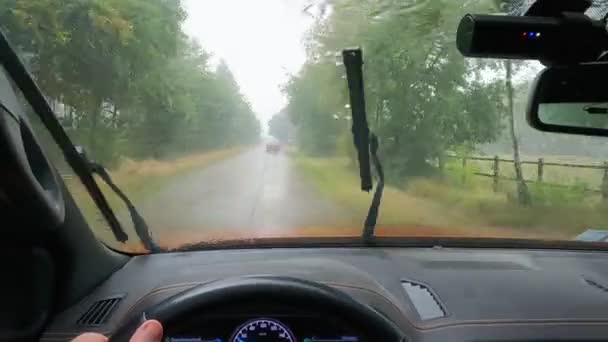 ウィンドシールドは車の内部から雨の景色で浸水しました Dvrは交通状況を捉えている ウィンドシールドワイパーは ガラス上のレインドロップを掃除します 湿ったスリッパリー道路の可視性が悪い 激しい雨が降った — ストック動画