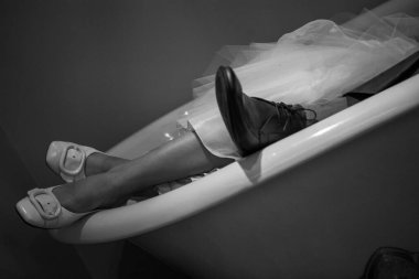 Bride and groom feet relaxing in a bathtub. High quality photo