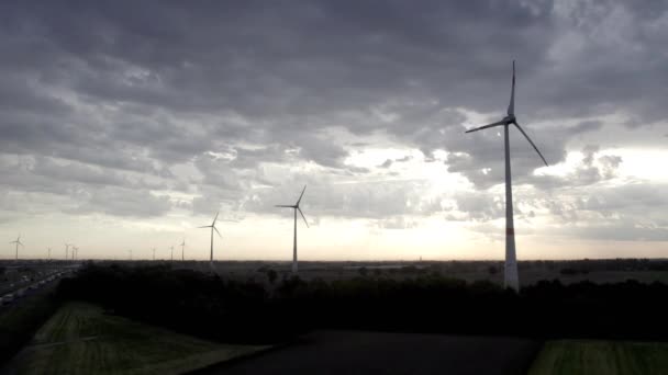 这段录像生动地展现了风力涡轮机在暴风雨的天空中高耸入云的景象 捕捉到了黑暗 沉思的云彩与利用自然力量的技术之间的反差 — 图库视频影像