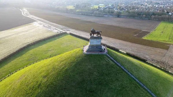 stock image Waterloo, Brussels, Belgium, February 25th, 2024, This aerial image captures the Lions Mound at the Waterloo Battlefield memorial. The sun, positioned on the horizon, casts a warm glow across the