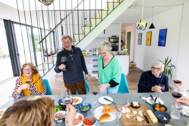 Canlı bir arkadaş grubu, gevşemek için canlı ve modern bir yemek alanında lezzetli yemek ve içeceklerin tadını çıkardı.