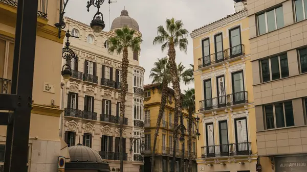 アンダルシア スペインのカレ プエルタ マルにあるマラガの観光地区にある古い住宅の建物とヤシの木の低い角度の景色 — ストック写真