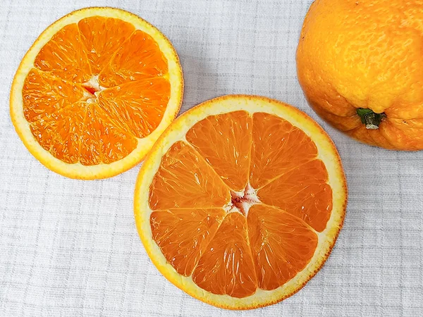 Zwei Hälften Saftige Orange Auf Einem Weißen Leinentischtuch Nahaufnahme Makro — Stockfoto