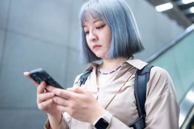  Tayvanlı bir kadın, Taipei metro istasyonunda tren bekliyor.