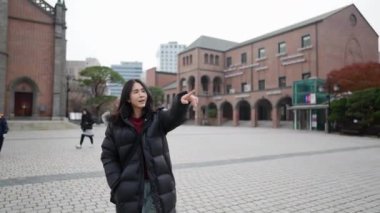 30 'lu yaşlarında uzun saçlı bir Koreli Myeong-dong, Seul, Güney Kore' de bir kilisede yürüyüş yapıyor.