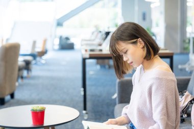 Tayvan 'ın Taipei şehrindeki Wenshan Bölgesi' nde güzel bir kütüphanede zaman geçiren 20 yaşındaki Tayvanlı bir kızın yavaş çekim videosu.