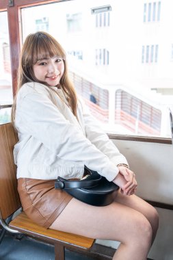 Hong Kong 'da tramvaya binen 20' li yaşlarda Çinli bir kadın.