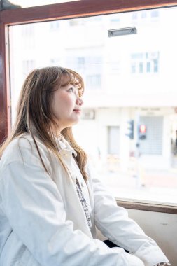 Hong Kong 'da tramvaya binen 20' li yaşlarda Çinli bir kadın.