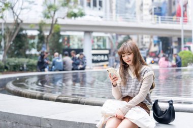 20 'li yaşlarda Çinli bir kadın Hong Kong' da yürüyüş yapıyor.