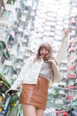 20 'li yaşlarda Çinli bir kadın Hong Kong' da bir parkta mola veriyor.