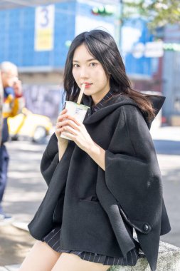 Tayvan 'ın Taipei şehrindeki Zhongshan İstasyonunda 20' li yaşlarda genç bir Tayvanlı kadın tapyoka içiyor.