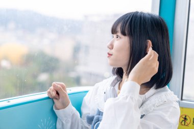 Tayvan 'ın Taipei şehrindeki Shilin semtinde bir lunaparkın dönme dolabında oynayan 20' li yaşlarında genç bir Tayvanlı kadın.