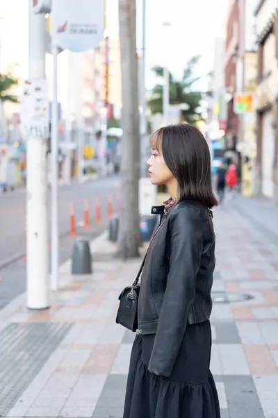 stock image A young woman from Okinawa Prefecture in her 20s walking around Kokusai-dori Street in Naha City, Okinawa Prefecture in a cold winter