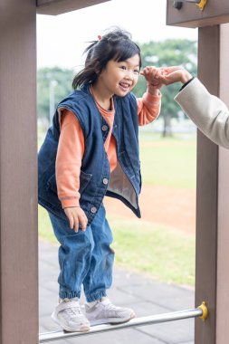 Tayvan 'ın Tayvan şehrindeki Datong Bölgesi' nde büyük bir parkta oynayan küçük bir Tayvanlı kızın çocuğu.