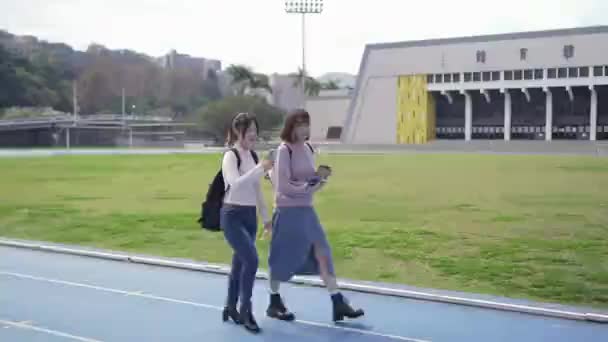 Två Taiwanesiska Kvinnliga Collegestudenter Årsåldern Som Promenerar När Talar Campus — Stockvideo
