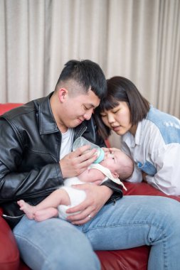 Yilan, Tayvan 'da yaşayan 20' li yaşlarında bir anne ve baba bir aylık Tayvanlı bebeğe bakıyor.