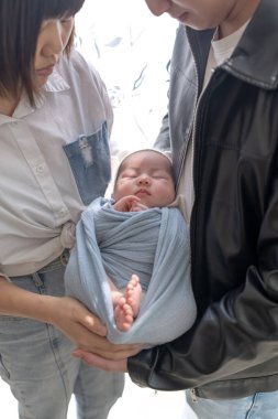 Yilan, Tayvan 'da yaşayan 20' li yaşlarında bir anne ve baba bir aylık Tayvanlı bebeğe bakıyor.