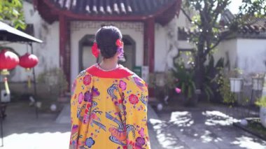 Ryuso 'da yirmili yaşlarda bir Japon kadın, Çin tarzı bir bahçede ağır çekimde yürürken görülüyor, bir kimononun zarafetini yansıtıyor.. 