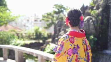 Ryuso 'da yirmili yaşlarda bir Japon kadın, Çin tarzı bir bahçede ağır çekimde yürürken görülüyor, bir kimononun zarafetini yansıtıyor.. 