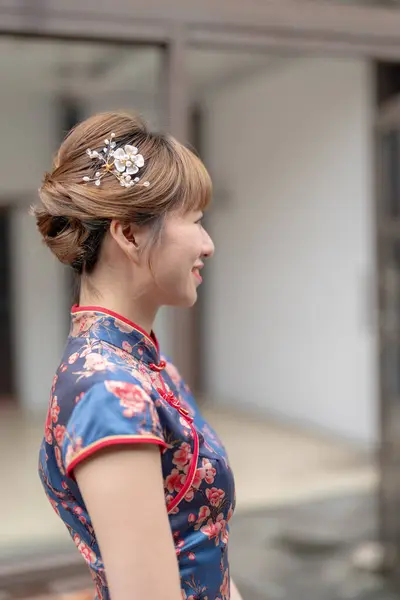 stock image Young Taiwanese woman in her 20s wearing a blue cheongsam, strolling through a cultural district in Wanhua, Taipei, Taiwan