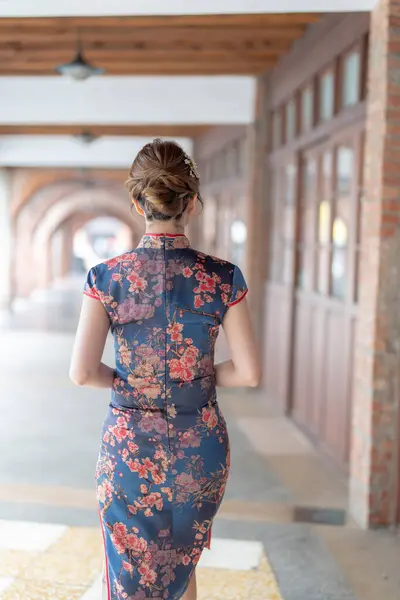 stock image Young Taiwanese woman in her 20s wearing a blue cheongsam, strolling through a cultural district in Wanhua, Taipei, Taiwan