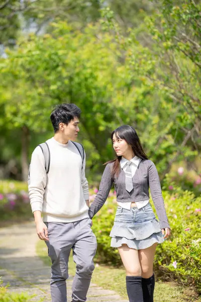 stock image In March, with hydrangeas blooming, a Taiwanese woman in her twenties and a Hong Kong man are enjoying a walk together in a park in Zhongzheng District, Taipei City, Taiwan.