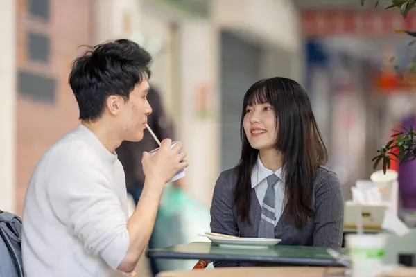 stock image March, near the Zhongshan Memorial Hall in Zhongzheng District, Taipei City, Taiwan, Taiwanese woman in her twenties and a Hong Kong man are enjoying a meal of soy milk and radish cake at local shop.