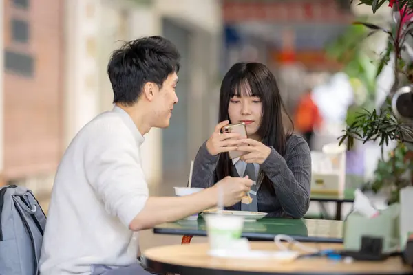 stock image March, near the Zhongshan Memorial Hall in Zhongzheng District, Taipei City, Taiwan, Taiwanese woman in her twenties and a Hong Kong man are enjoying a meal of soy milk and radish cake at local shop.