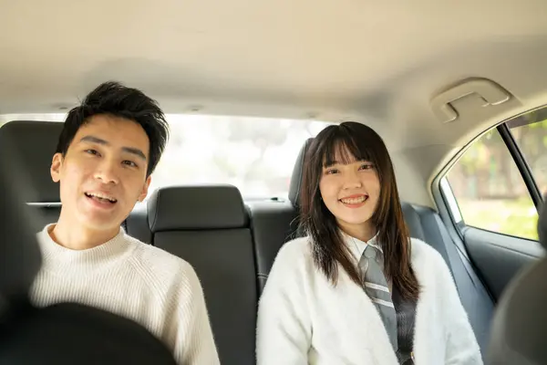 stock image In March, a Taiwanese woman in her twenties and a Hong Kong man are taking a taxi to their next destination on a public road in Zhongzheng District, Taipei City, Taiwan.