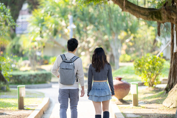 In March, a Taiwanese woman in her twenties and a Hong Kong man are walking in a park near Zhongshan Memorial Hall in Zhongzheng District, Taipei City, Taiwan.