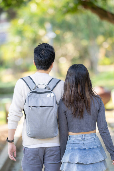 In March, a Taiwanese woman in her twenties and a Hong Kong man are walking in a park near Zhongshan Memorial Hall in Zhongzheng District, Taipei City, Taiwan.