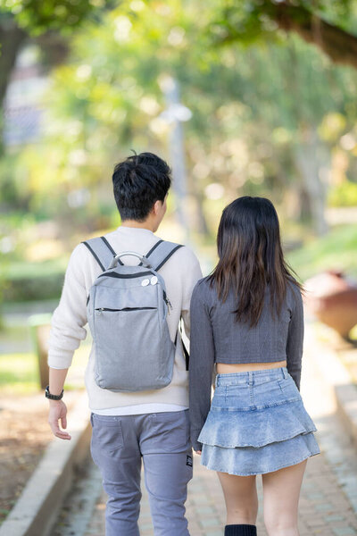 In March, a Taiwanese woman in her twenties and a Hong Kong man are walking in a park near Zhongshan Memorial Hall in Zhongzheng District, Taipei City, Taiwan.