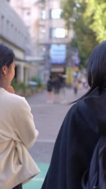 Tayvanlı 20 'li yaşlarda erkek ve bayan öğrenciler ve Tayvan' da Da 'an Bölgesi' nde bir üniversite kampüsünde sohbet eden Hintli bir kadın. Dikey.