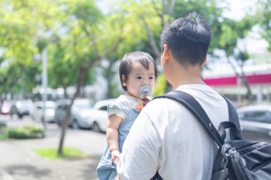 Tayvanlı bir kız, Eylül 'de Tayvan' ın Tayvan şehrinin sokaklarında güneşli bir günde, 20 'li yaşlarda bir adam olan babasıyla dışarı çıkıyor..