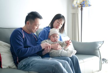 6 aylık bir çocuk Çin 'deki Pudong Yeni Alanı' ndaki bir apartman dairesinde soğuk bir kış günü Çinli bir aileden gelen anne ve babasıyla kanepede vakit geçiriyor.. 