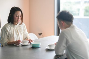 30 'lu yaşlarda Japon bir kadının evde piyano çaldığı dikey video..