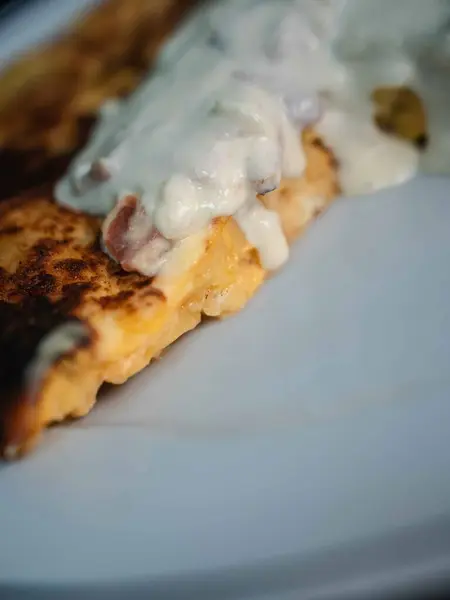 Lezzetli patates omletimizle İspanyol geleneğinin ve İtalyan yeteneğinin enfes bir karışımını deneyin. İçinde taze patates, yumurta ve lezzetli bir carbonara sosu var. El değmemiş beyaz bir tabakta, çarpıcı bir siyah zemine karşı servis edilmiş, mükemmel. 
