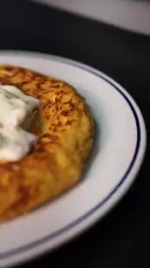 Otantik İspanyol patatesli omletimizle Galiçya mutfağının özünü deneyin. Taze yumurta, patates ve zeytinyağıyla yapılan bu yemek İspanyol gastronomisinin temel maddesidir. Yuvarlanan bir yakın çekim ile çekilen bu resim aşçılığı gösteriyor.