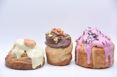 Three handmade New York roll with white, pink and black icing