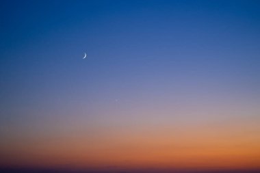 Vibrant sunset sky background of orange and blue colours.