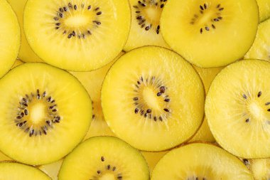 Golden kiwi fruit pattern. Healthy food background, directly above. 