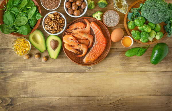 Selection of Omega-3 rich food sources on wooden background. Directly above, copy space. 