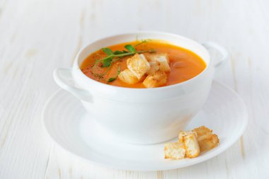 Pumpkin soup with croutons on white background. Close up. 