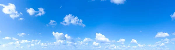 stock image Panorama of clear blue sky background with small white clouds.