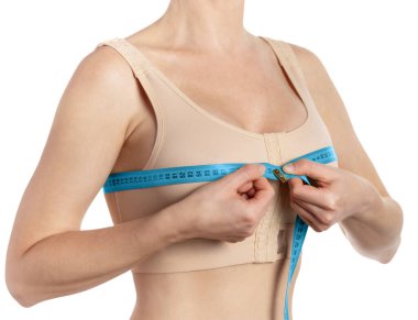 Woman taking measurements after breast augmentation isolated on white background with clipping path. Plastic surgery clipart