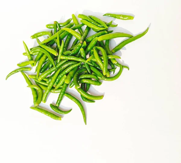 Fresh green chillies in white background