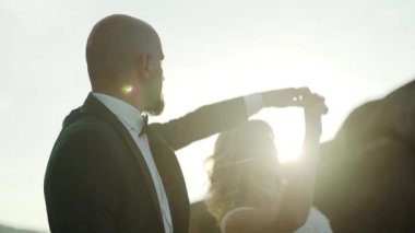 İnanılmaz manzara manzarasında, birbirlerine sarılırlar ve büyük kayalıkların ve kayaların arka planında romantik hissederler. Çift gün batımında ağır çekimde dans ediyor. Yüksek kaliteli FullHD görüntüler