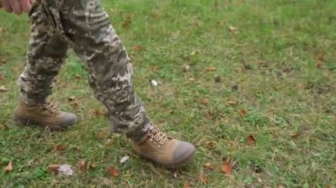 a soldier walks on the ground. Close-up of shoes. Slow-motion. High quality FullHD footage
