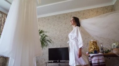 A white veil blowing in the wind. Couple standing near yacht. Slow motion. High quality FullHD footage